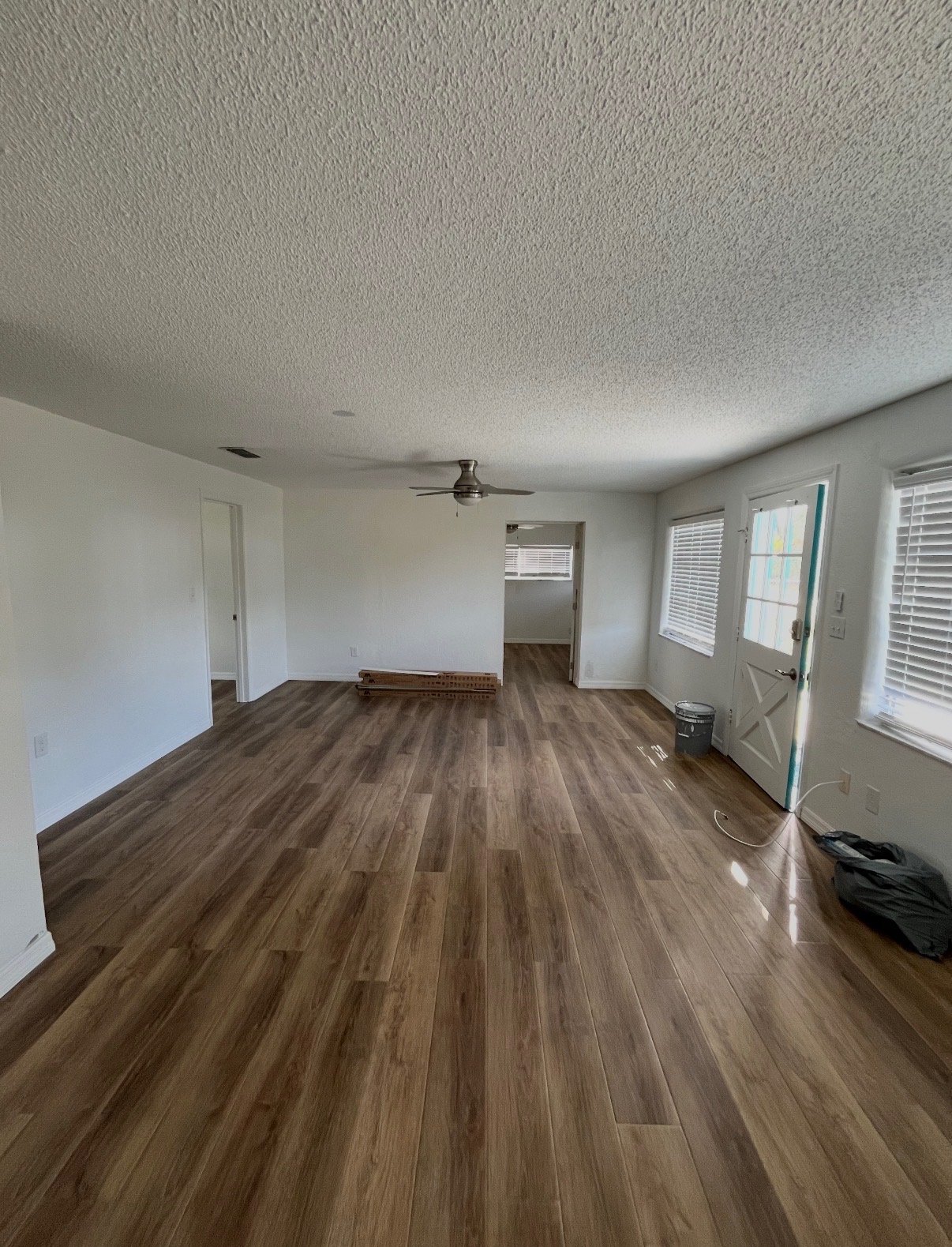 Finished flooring in an open living room near the front door